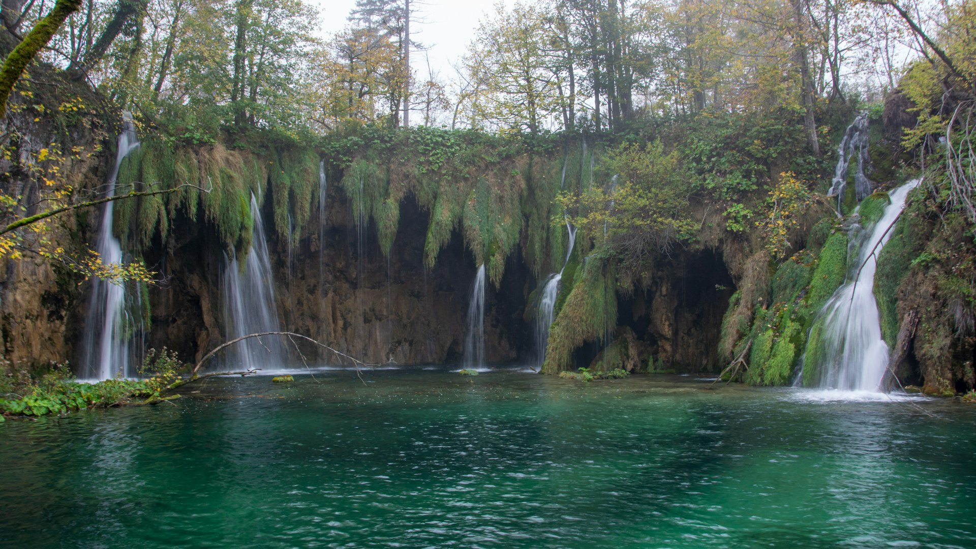 Panoramic view of Plitvice Lakes with waterfalls and trees in spring