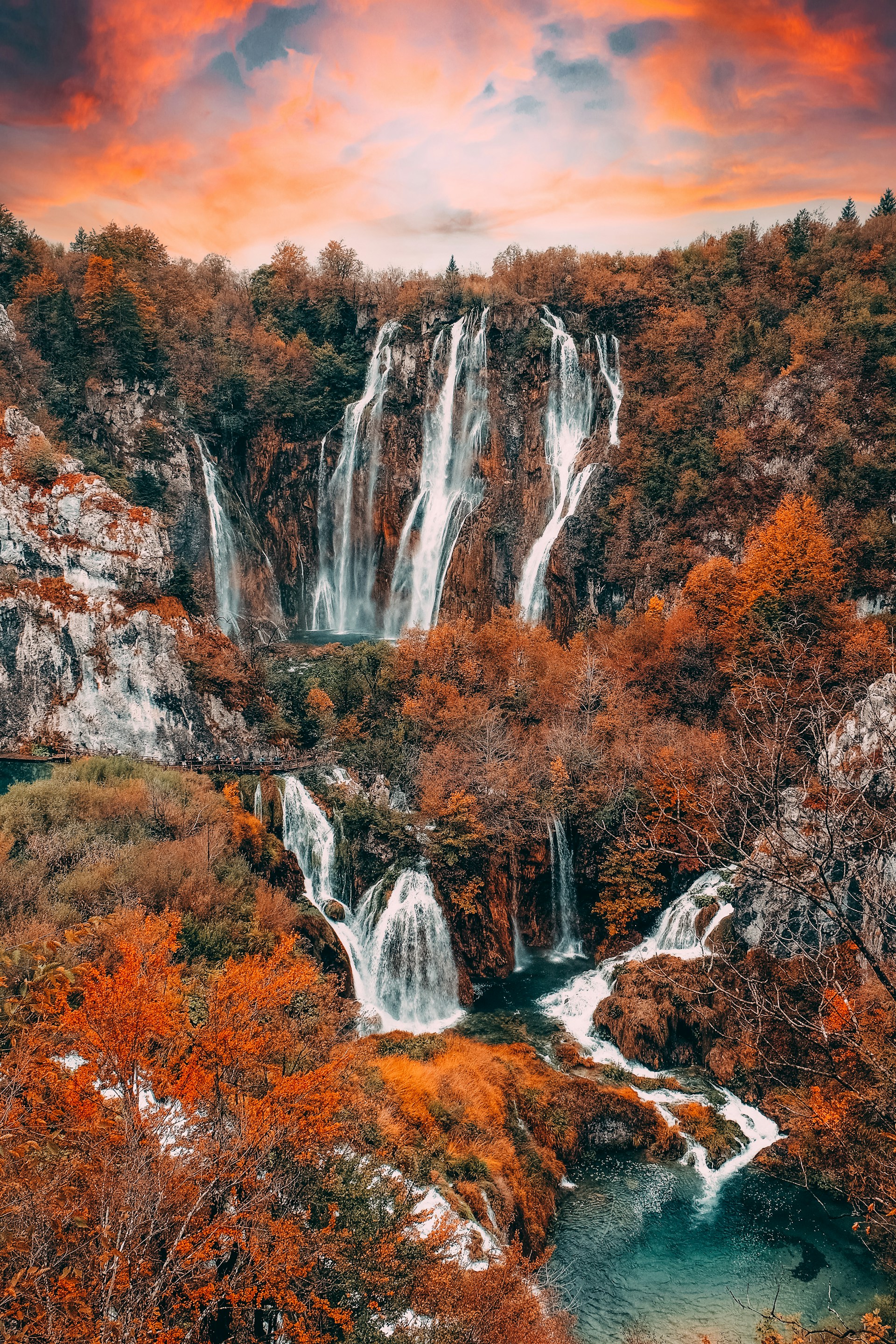 Sunrise over cascading waterfalls at Plitvice Lakes with golden light