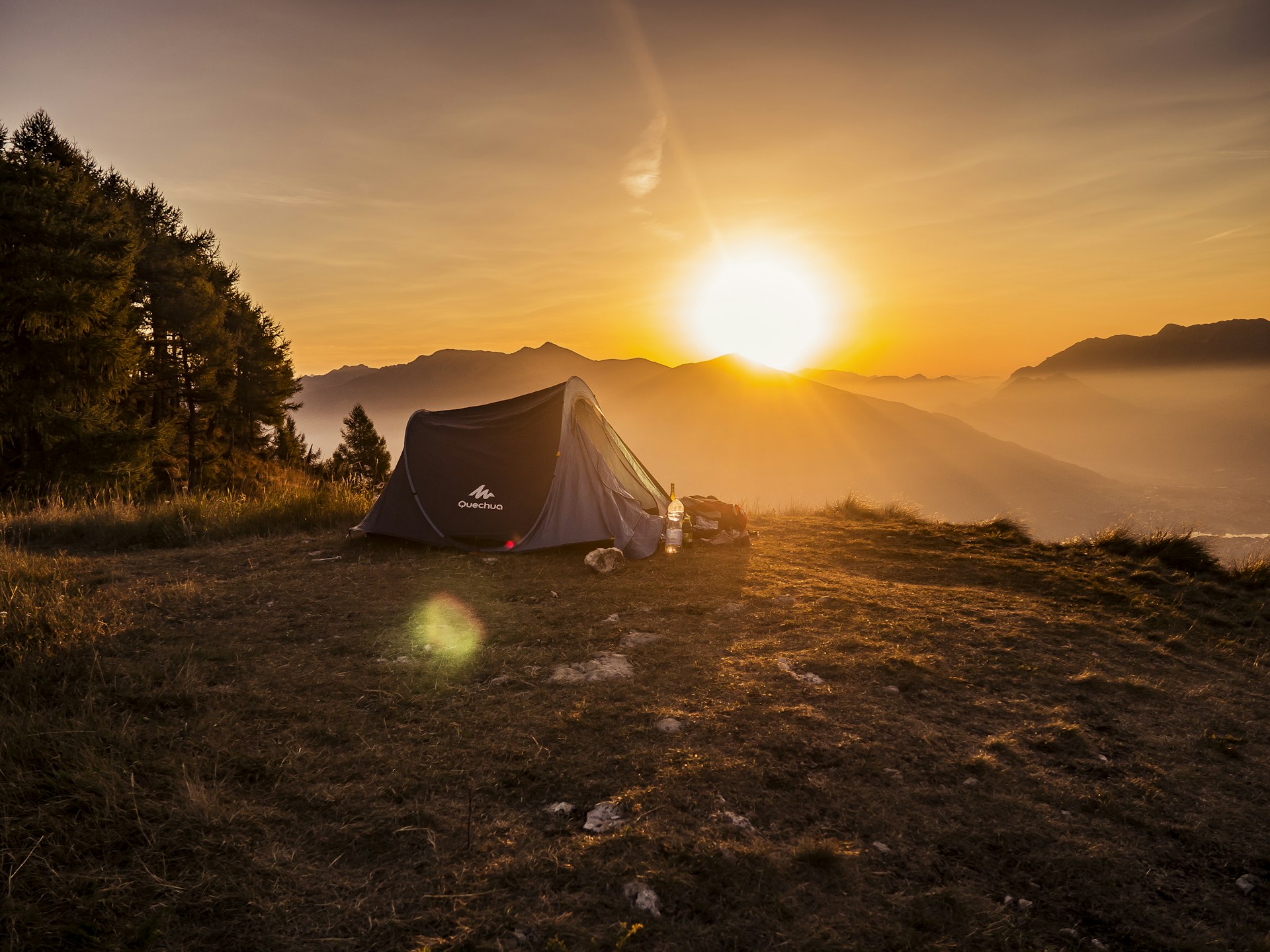 Tent camping with beautiful morning sunrise through trees